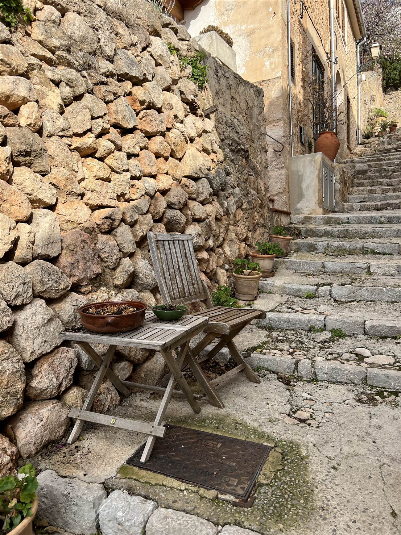 Stone steps rising beside a dry stone wall on a terraced Mallorcan hillside