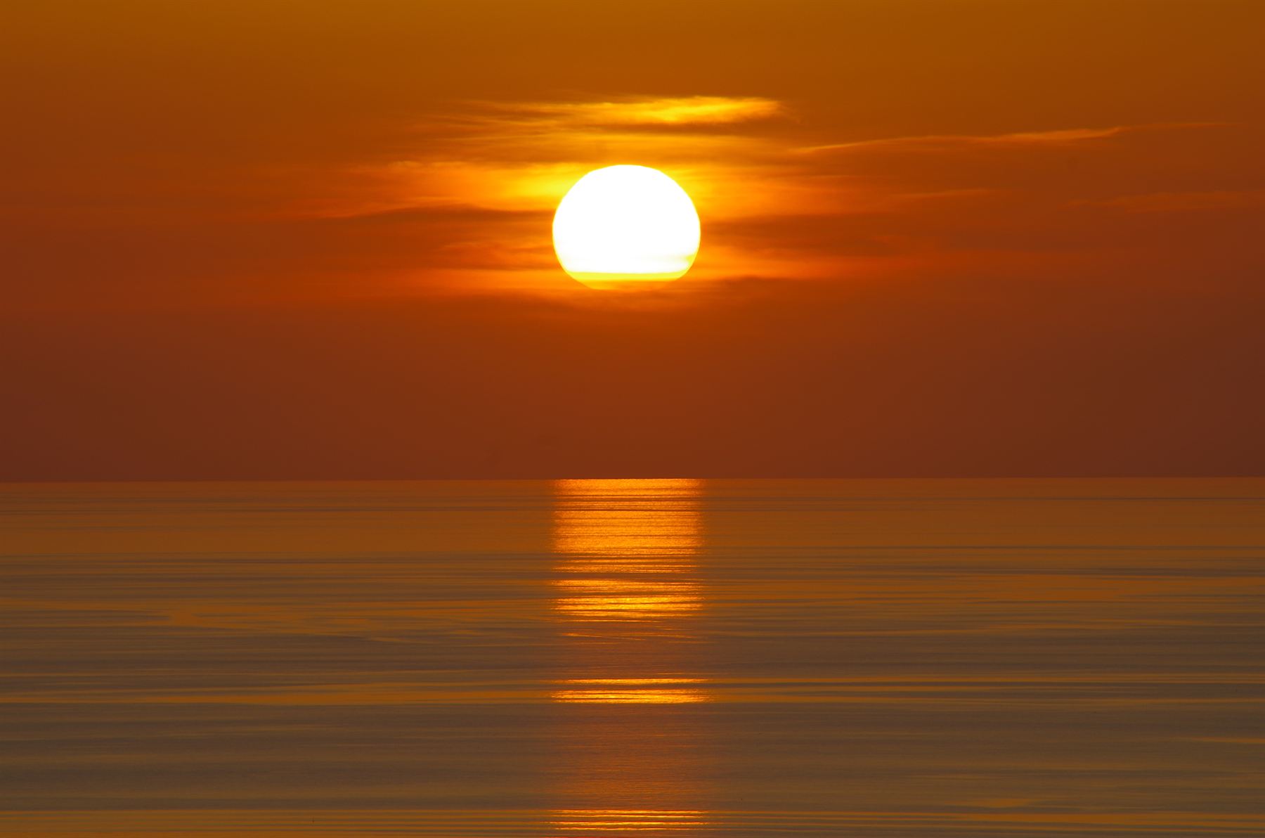 The sun setting over a calm Mediterranean sea off the Mallorcan coast