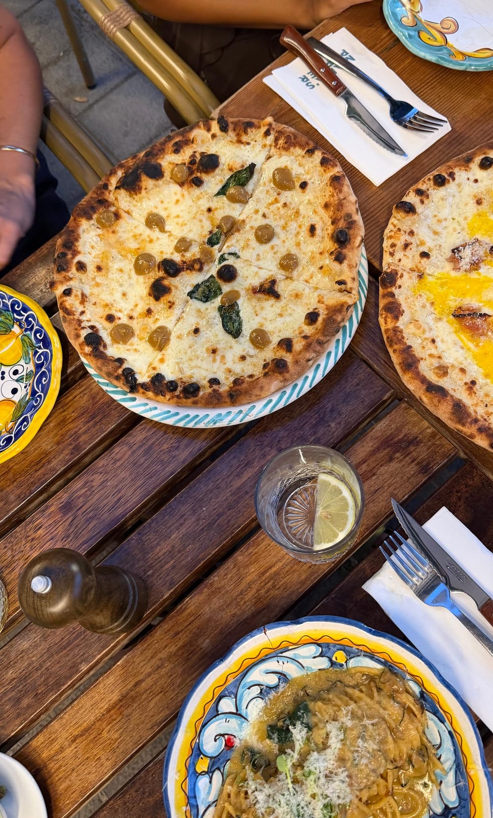 A long shared table of dishes at a Mallorcan restaurant, mid meal
