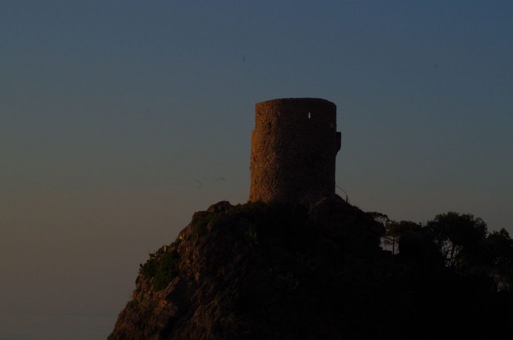 The Torre des Verger watchtower on a headland above the sea at dusk on Mallorca's west coast